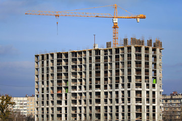 Kiev, Ukraine - February 17, 2019: Сonstruction of a new multi-story residential building. Crane and construction site. Modern apartment building is being building