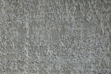 Gray concrete wall, background. The texture of the old wall with exfoliated whitewash, darkened by old age