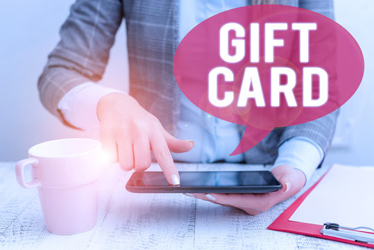 Text sign showing Gift Card. Business photo showcasing A present usually made of paper that contains your message Business woman sitting with mobile phone and cup of coffee on the table