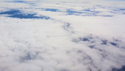 White clouds blue sky from aeroplane window aerial