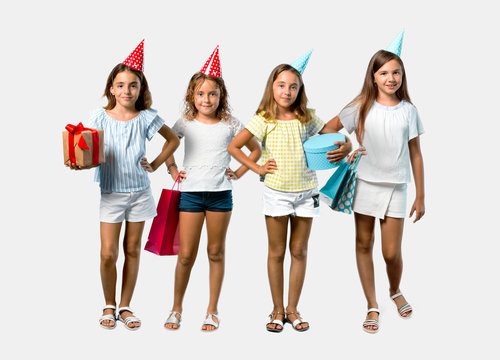 Set of Little girl at a birthday party holding a gift bag posing with arms at hip on grey background