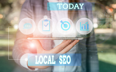 Text sign showing Local Seo. Business photo showcasing This is an effective way of marketing your business online Female human wear formal work suit presenting presentation use smart device