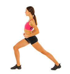 Fototapeta premium Young healthy girl doing exercises, full length portrait isolated over white background
