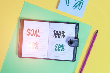 Conceptual hand writing showing Goal 100 Percent 90 Percent 80 Percent. Concept meaning Percentage of your objectives fulfilment success level Locked diary striped sheets clips notepad colored