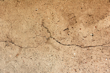 Texture of a concrete wall with cracks and scratches which can be used as a background