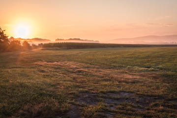 Obraz premium Sunrise over a farm field, Pine Island, NY, early fall