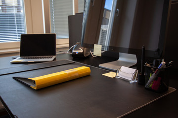 Naklejka premium Office desk yellow folder. Laptop with external screen.