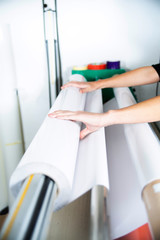 Advertising banner printing. The printing flotter, printer operates the machine