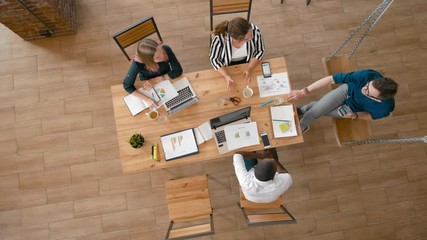 Overhead Diverse Business Casual People Meeting for Project Discuss using Laptops. Top View of Startup Employees Team Working in Loft Office with Swing. 4K High Angle Long Gimbal Background Shot
