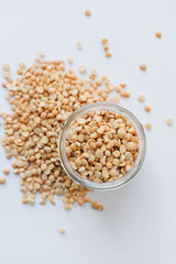 Glass jar with raw dry peas, macro
