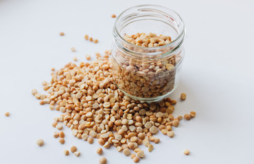 Glass jar with raw dry peas, macro