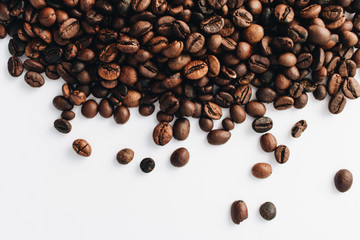 Close-up view of roasted coffee beans and glass cup