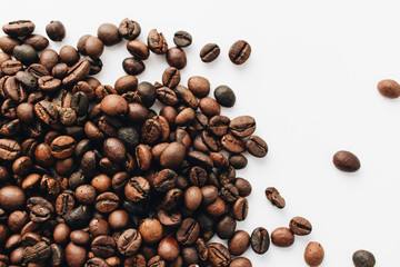 Close-up view of roasted coffee beans and glass cup