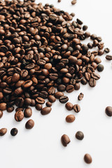 Close-up view of roasted coffee beans and glass cup