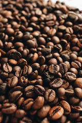 Close-up view of roasted coffee beans and glass cup