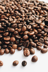 Close-up view of roasted coffee beans and glass cup