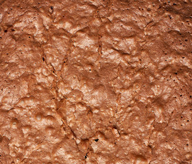 fragment of baked brownie chocolate cake with cracked surface