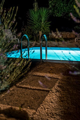 Mediterranean Garden With Illuminated Pool In The Night