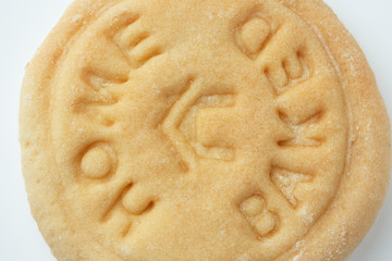 Macro Whole grain flour cookies with the stamp home baked on a white background. Close up and crop.