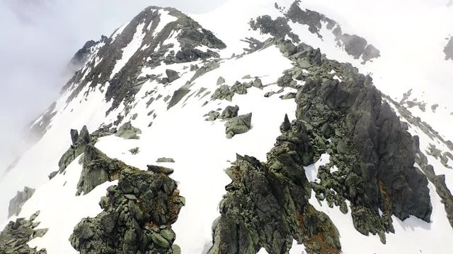 Aerial: Snowy Mountain Ridge with Amazing Cliffs in the Clouds - Le Brevent, France