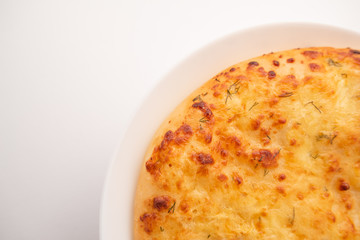 Fresh round cake on white plate on white background.