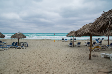 Deserted beach in bad weather, dark clouds over the sea.