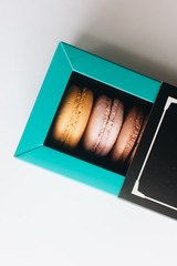 Box with delicious bright macaroons, sweet dessert