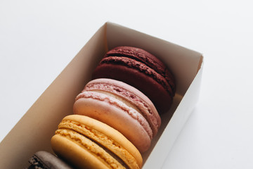 Box with delicious bright macaroons, sweet dessert