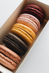 Box with delicious bright macaroons, sweet dessert