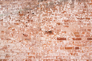 Old orange brick wall with cracks on the bricks. shabby vintage wall