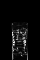 Vodka or gin tonic with ice in rocks glass on black background