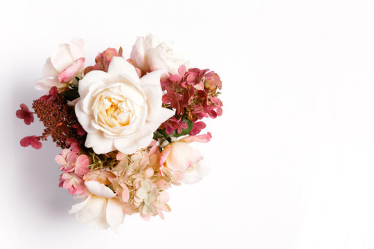 Autumn bouquet of flowers in red, burgundy colors. Roses, hydrangea. Flower composition on white background.