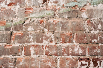 Old orange brick wall with cracks on the bricks. shabby vintage wall