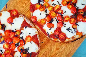 Pizza with fresh cherry tomatoes, mozzarella and opal basil on a cauliflower crust