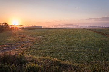 Sunrise over a farm field, Pine Island, NY, early fall