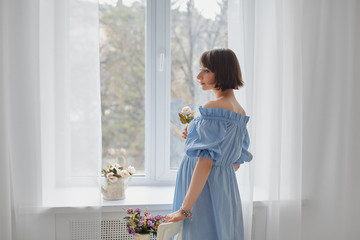 Pensive pregnant woman dreaming about child. Young happy expectant thinking about her baby and enjoying her future life. Motherhood, pregnancy, happiness concept, copy space