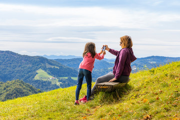 Modern lifestyle in the nature. Active mother and daughter.