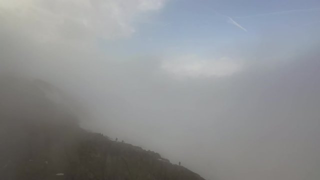 Aerial: Tourists Standing on Mountain Ridge in the Clouds - Le Brevent, France