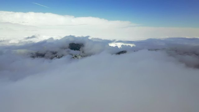 Aerial Forward: Amazing Snowy Mountains in Thick Clouds - Le Brevent, France