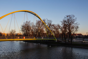 Fototapeta premium Pedestrian bridge over the river Odra in the Old Town of Wroclaw at sunset. Poland