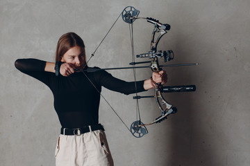 Archer woman with modern block sport olympic bow and arrow