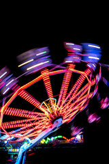 Colorful Light Trail From A Fast Carrousel At A Fun Park In The NIght