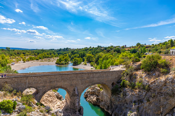 Fototapeta na wymiar Pont du Diable (Devil's bridge), near St Guilhem du Desert, Herault, Languedoc Roussillon, old bridge on the herault river