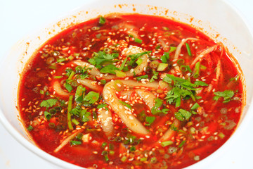 Vermicelli red hot soup in white porcelain bowl