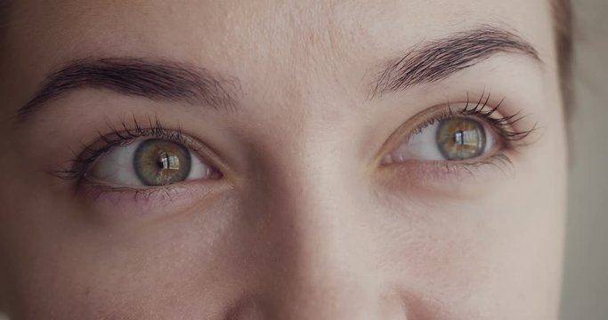 Close-up view on woman blinks and looks away.