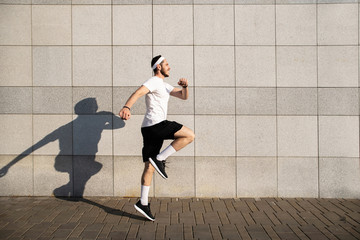 Handsome man running in the city. Fitness, workout, sport, lifestyle concept.