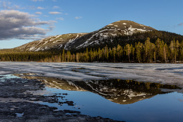 A mid May landscape of hills and melting lake ice, Lapland, Finland
