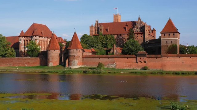 Malbork Castle. Old Historical Teutonic fortress landmark on Nogat river at summer day in Poland Europe
