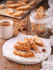 Traditional Catalan biscotti carquinyolis, cookies or cantuccini, with almonds nuts and coffee. Wooden table with copy space. Close up. Still Life concept, bakery product.