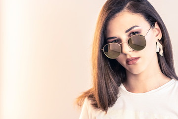 beautiful girl on white background. Girl holding pen for notes, glasses. The concept of beauty services, botox, skin care, modern fashion, blog, notes